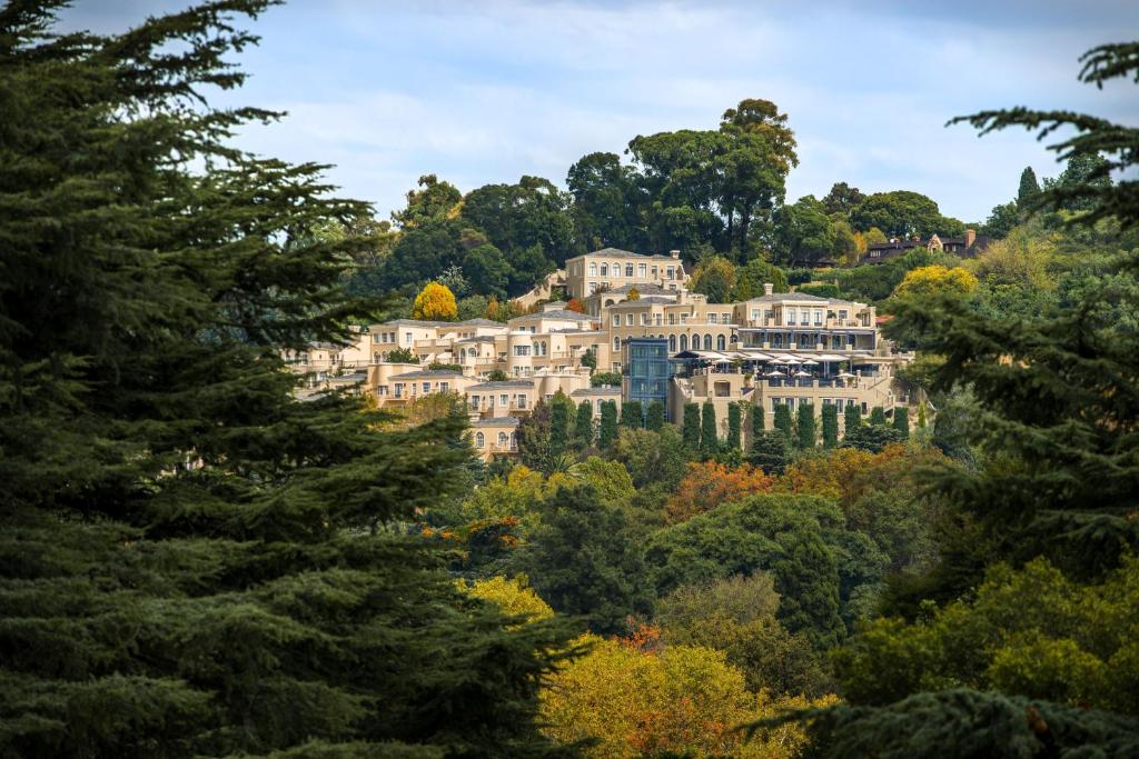 A luxurious suite with a private balcony overlooking the city at the Four Seasons Hotel The Westcliff.
