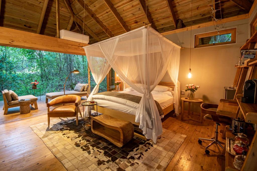 A luxurious suite with a private deck overlooking the river at Summerfields Rose Retreat & Spa.